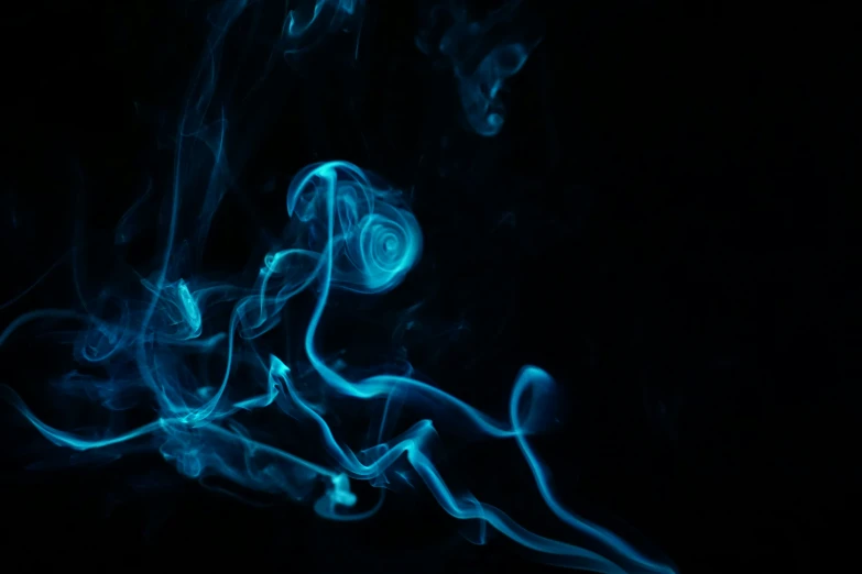 blue smoke is seen rising from a black background
