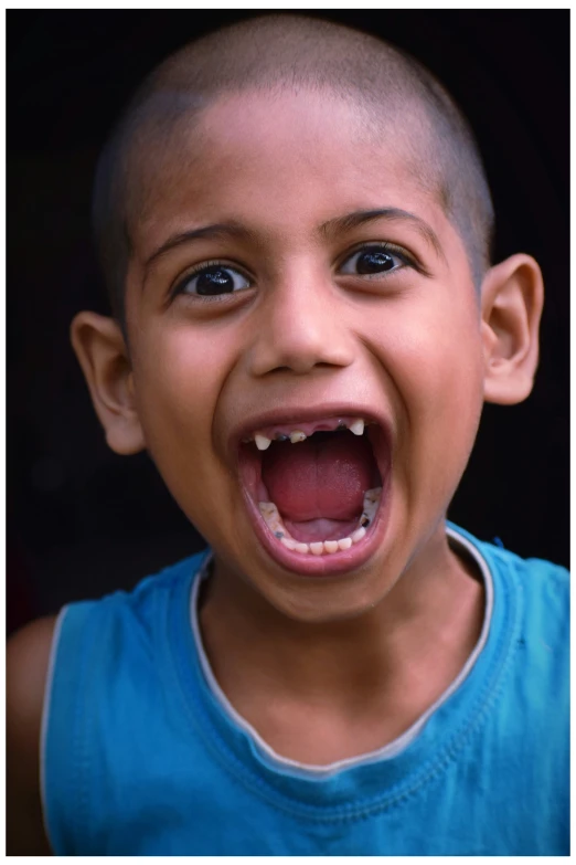 a boy with his mouth open and tongue out