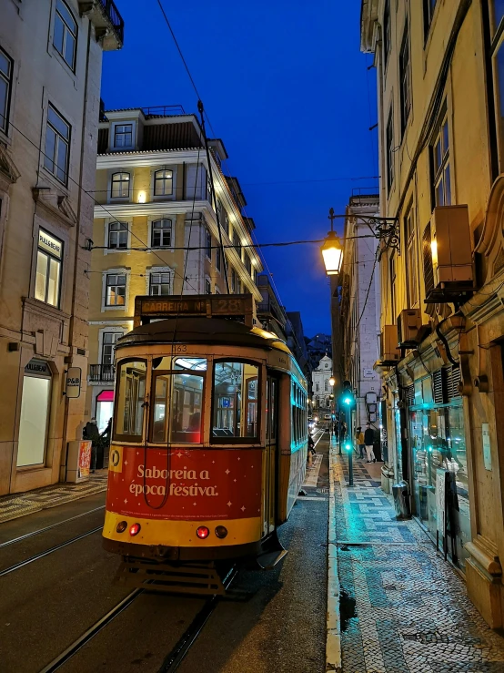 a trolley is in a quiet street at dusk
