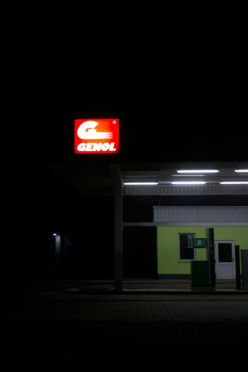 a gas station with a sign and gas pumps
