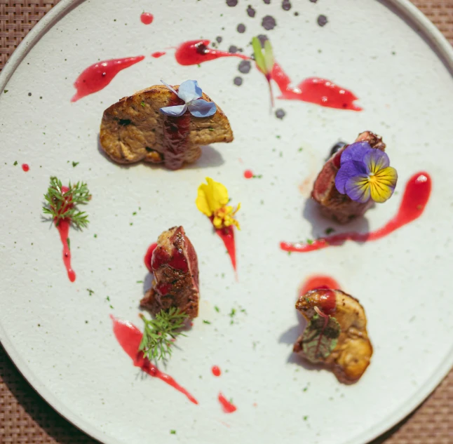 some small vegetables and sauces on a white plate