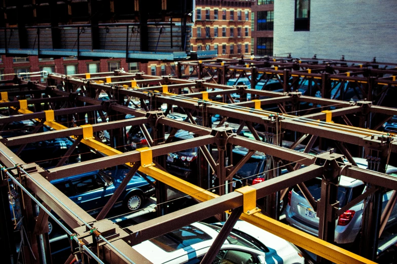 a parking lot with parked cars and metal frames