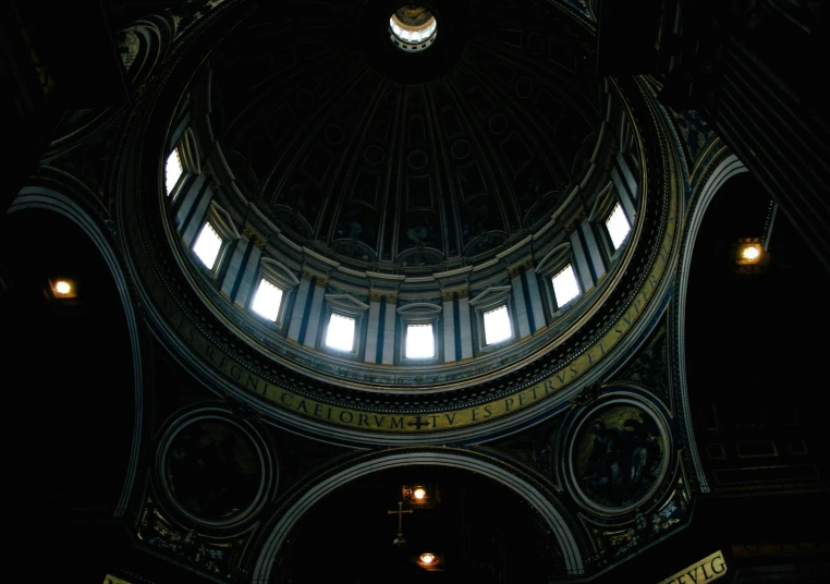 there are some lights on the ceiling inside of the building