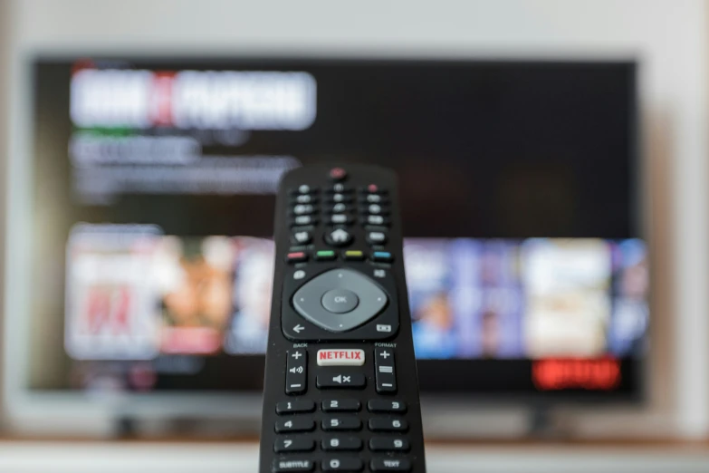 a remote control pointed at the tv and television screen