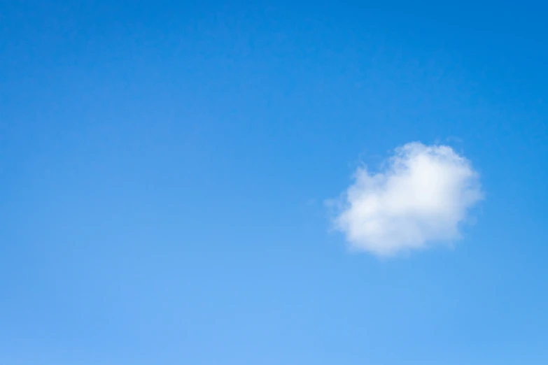 a very big cloud on a bright blue day