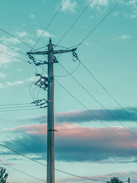 an electric pole in front of an open field