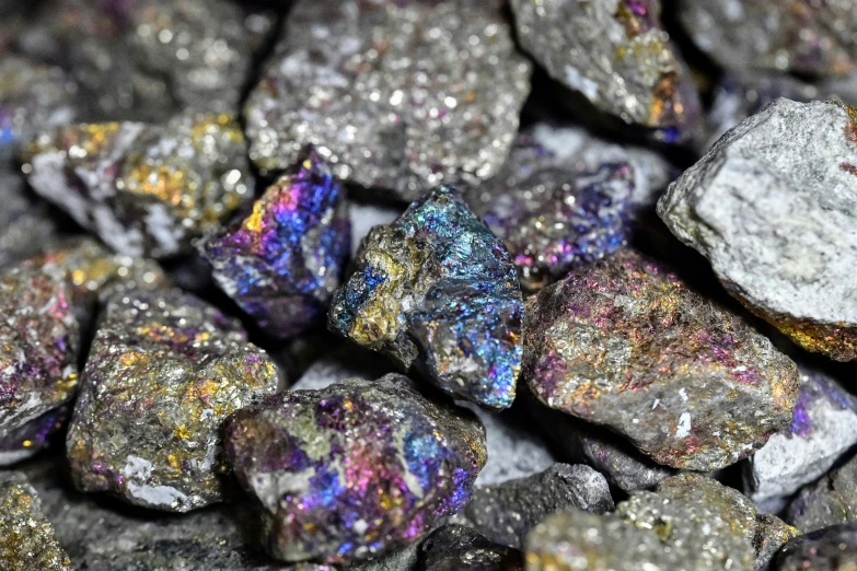 many small rocks with various colored glitters and textures