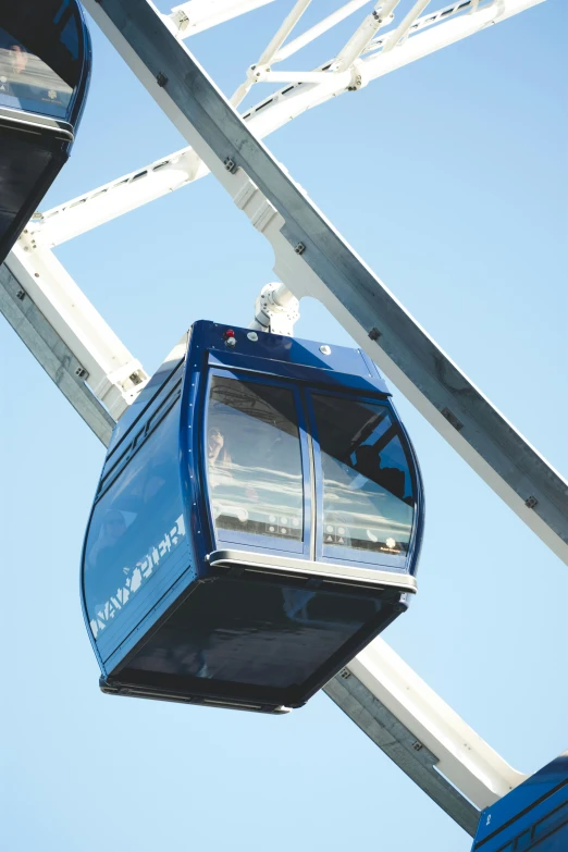 a po taken up in the air looking at a blue lift with chairs below