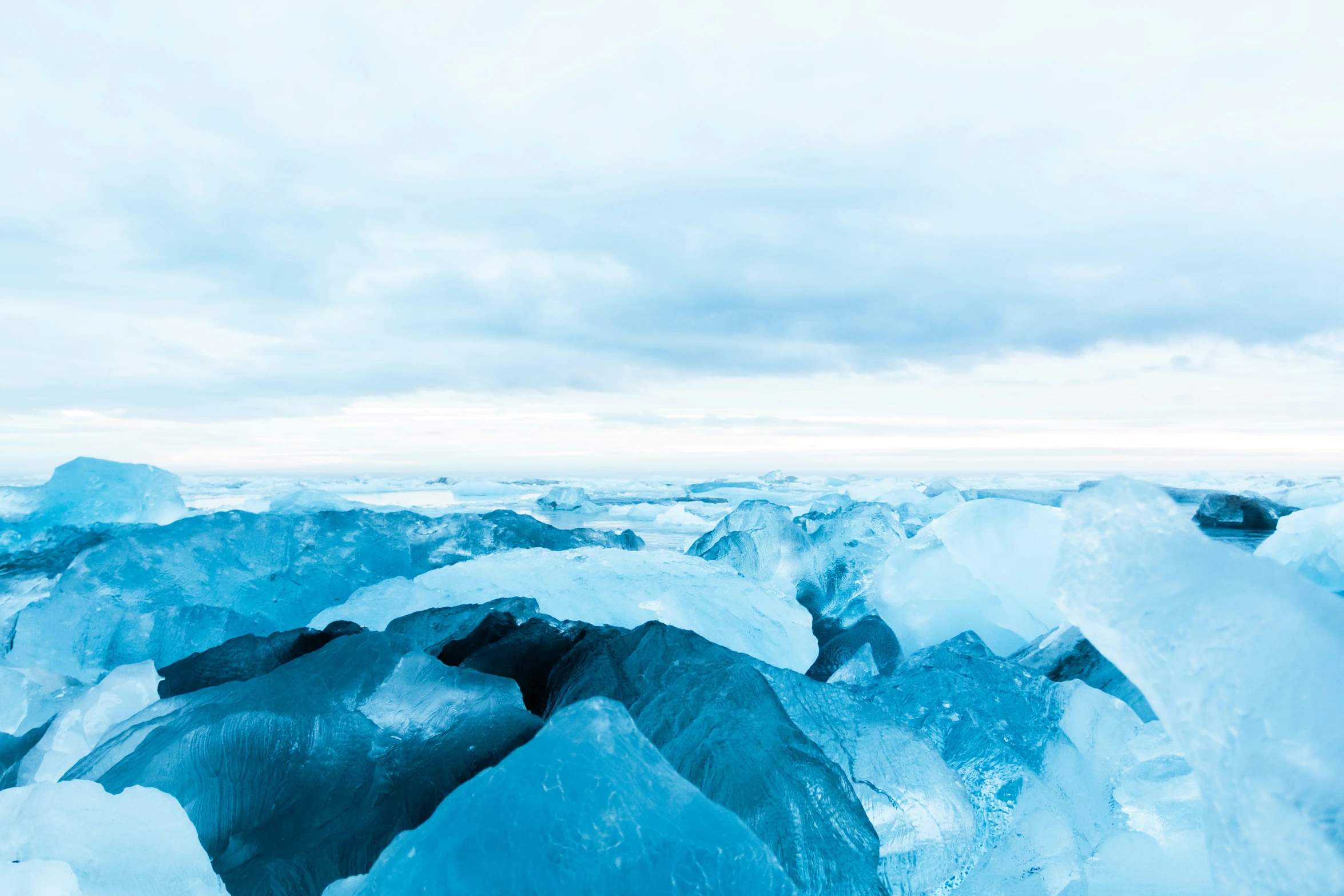 a couple of large blue ice chunks near one another