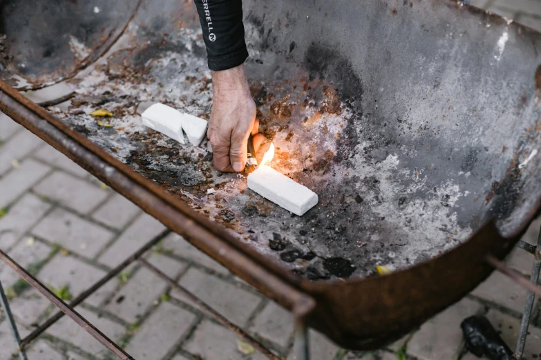 a fire burning with the hands of a person using a lighter