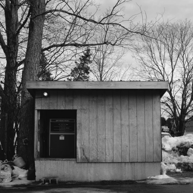 a small building sits next to some snow