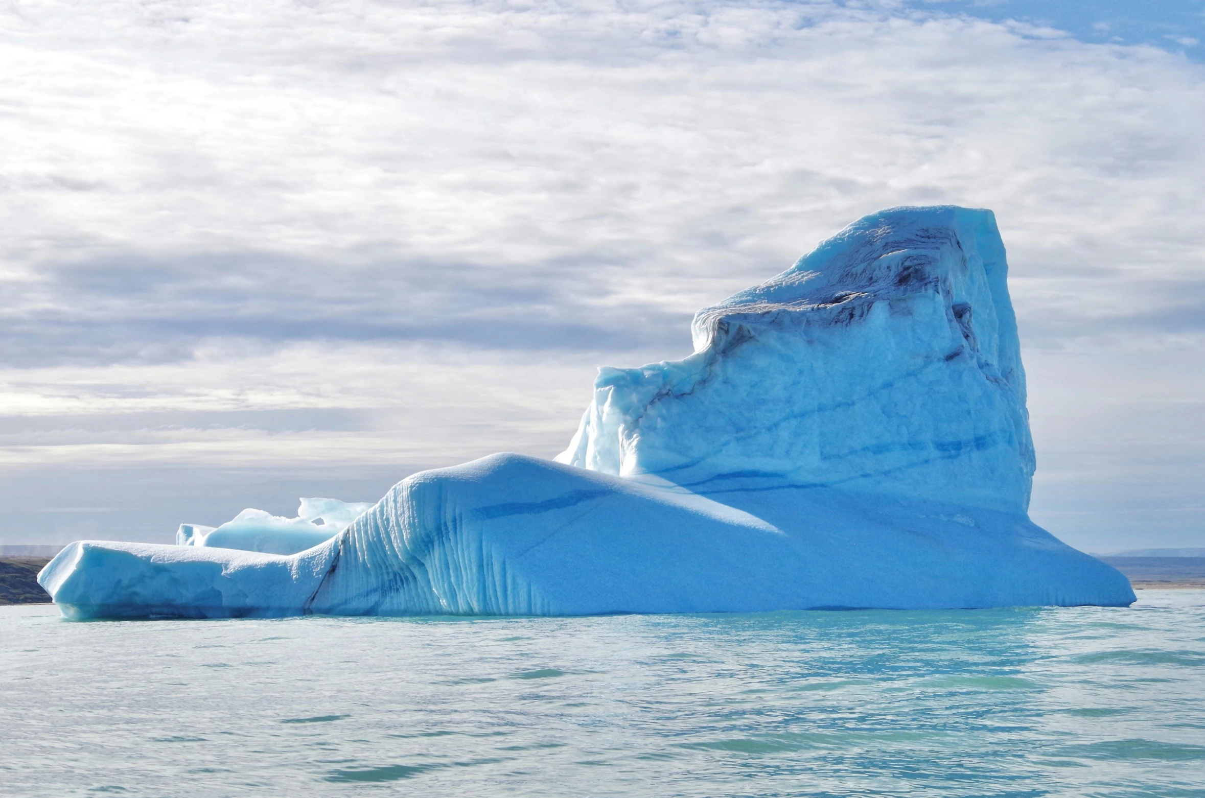 the large iceberg is floating on the ocean