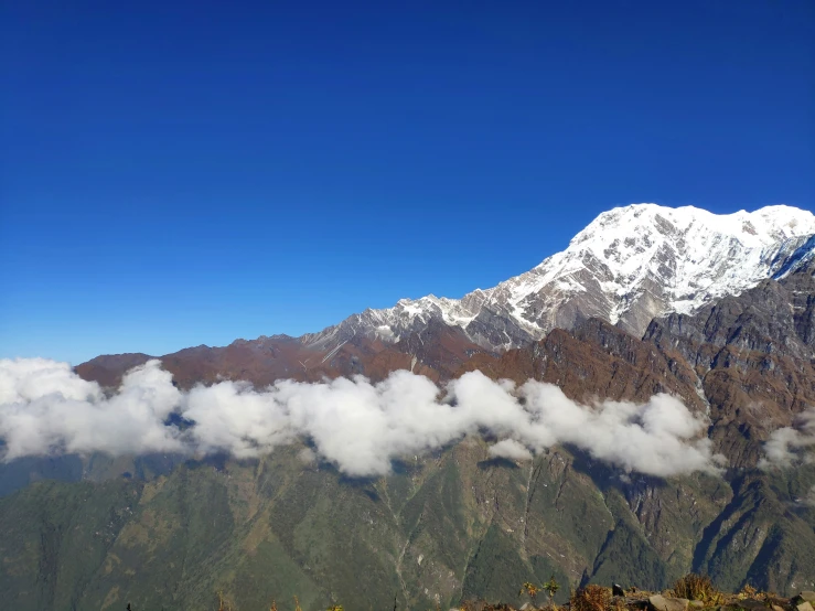 the top of the mountain with some very large clouds hanging in front of it