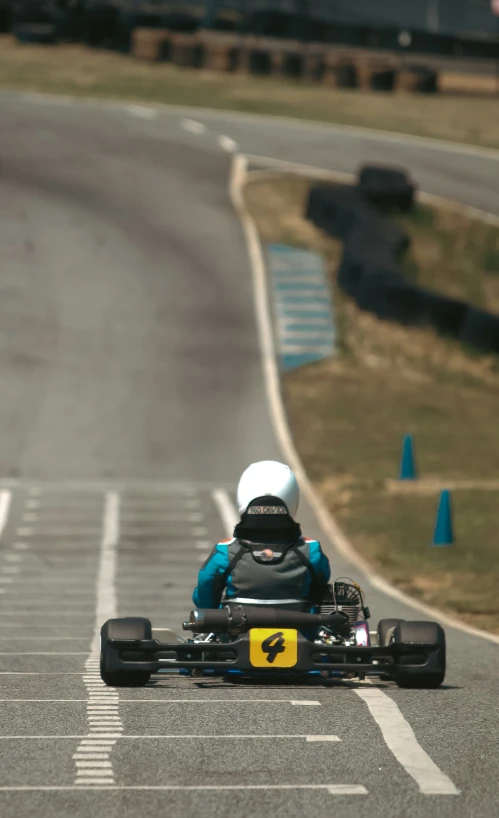 a small race car is racing down the road