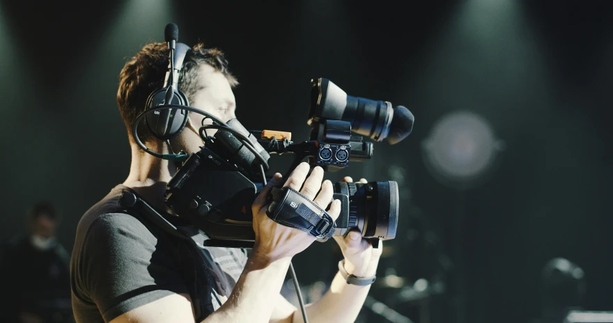 a man on the set of a video camera