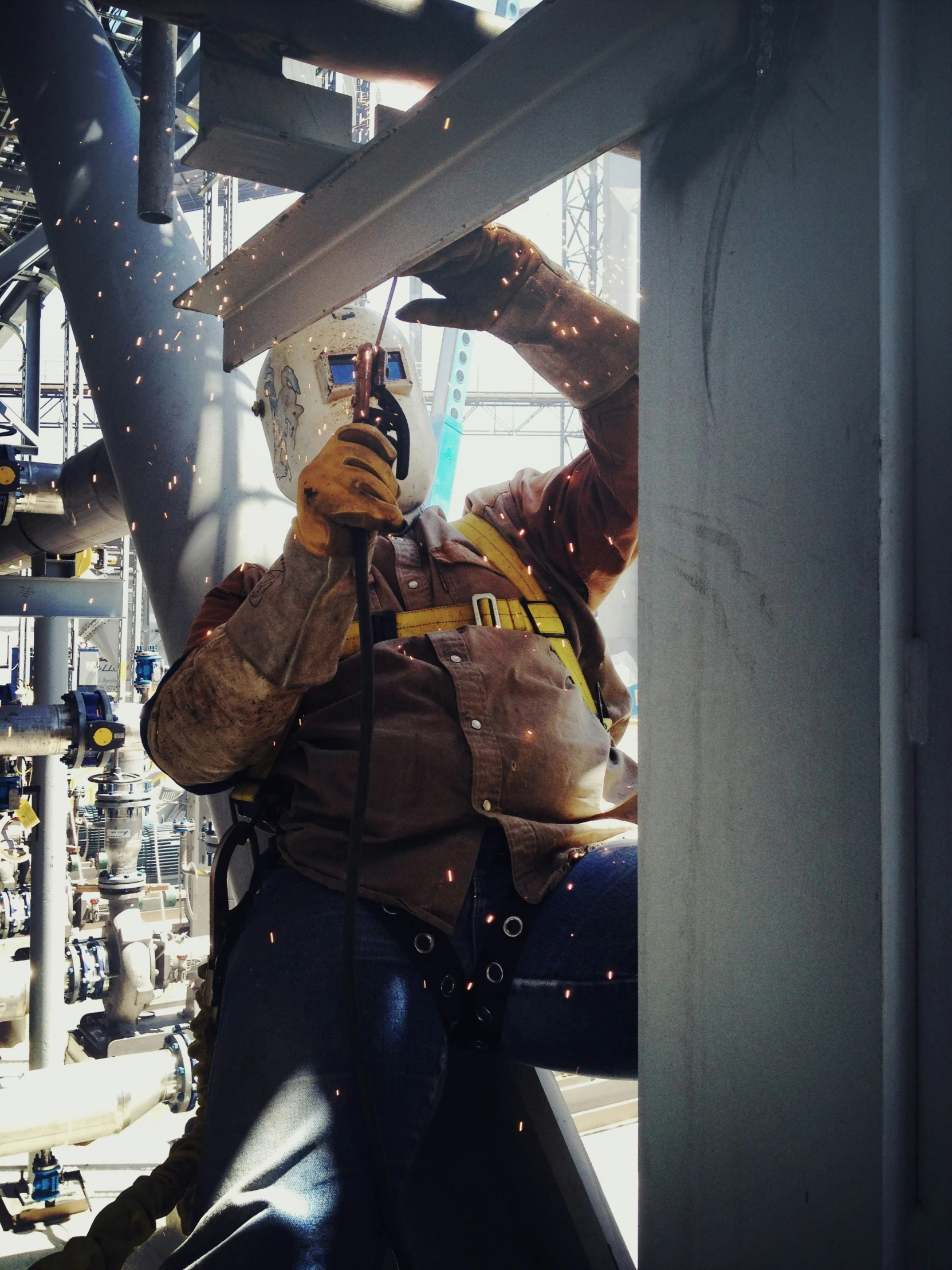 a person wearing welding gear holding a camera