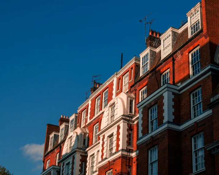 a large brick building with many windows in a city