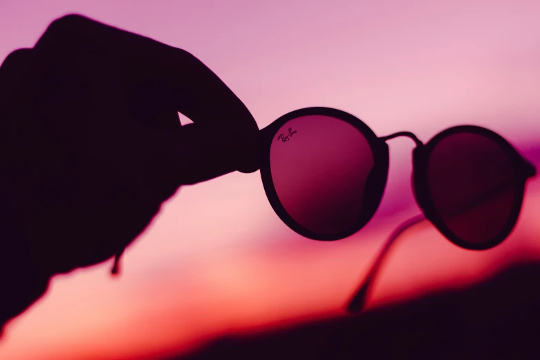 the reflection of a pair of sunglasses in its hands