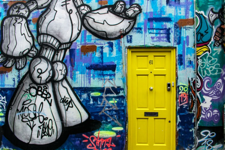 a door is in the corner of this colorful graffiti wall