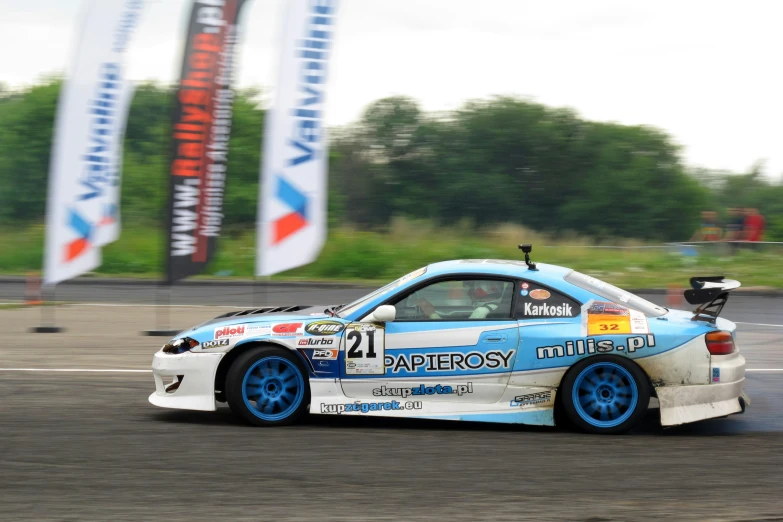 a very cute car that is kicking up some dirt