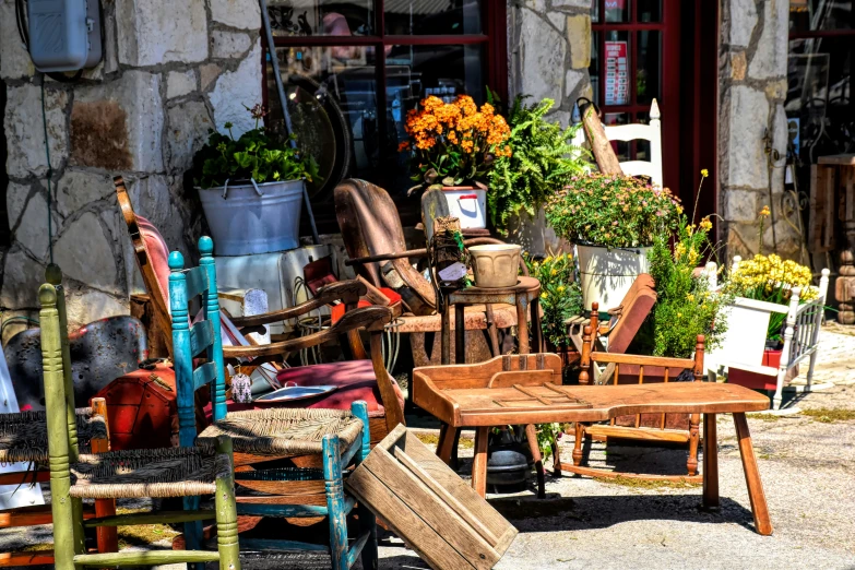 old furniture is displayed outside a building with pots and pans