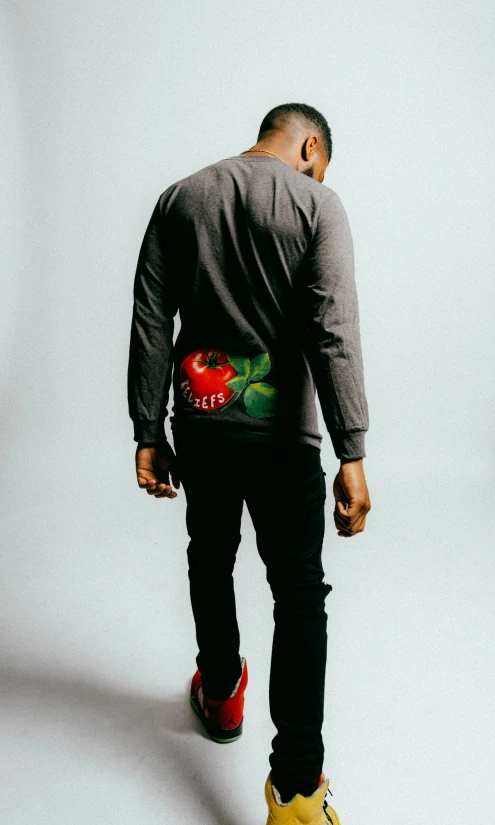 a man with a shirt painted with a fruit design