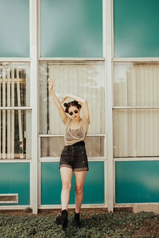 a girl poses for a po in front of a building