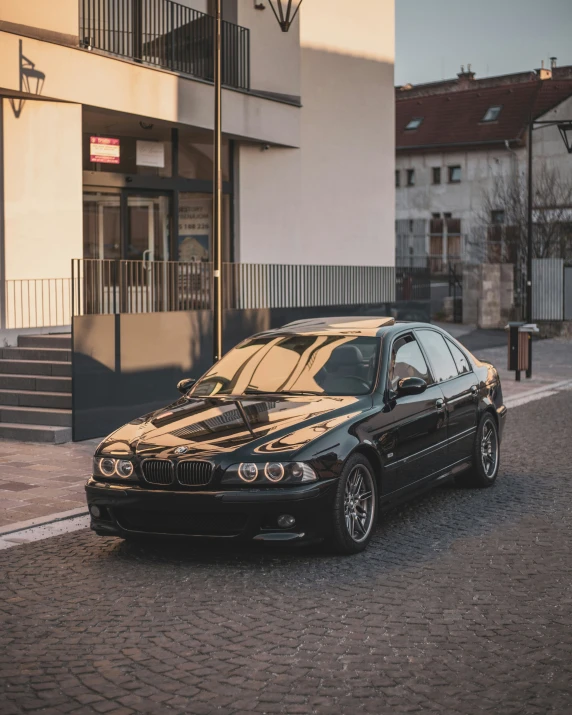 a black bmw parked in front of a building