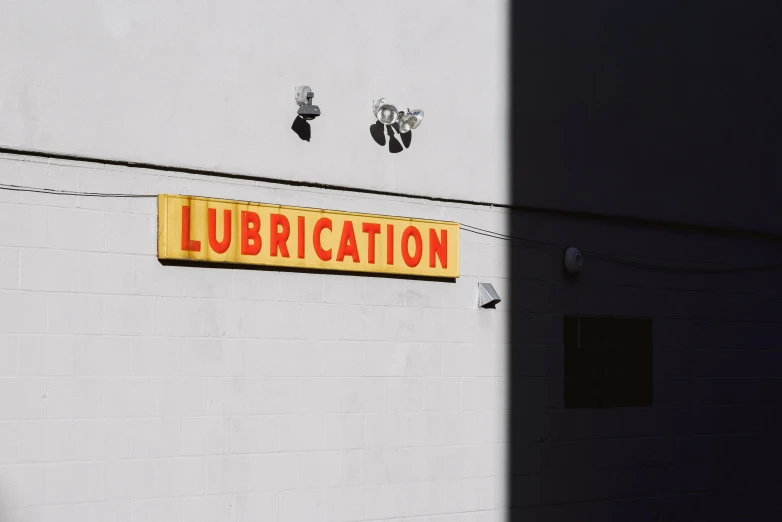 a yellow sign is hanging off the side of a building