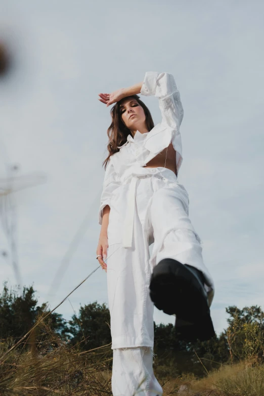 a woman standing on top of a field