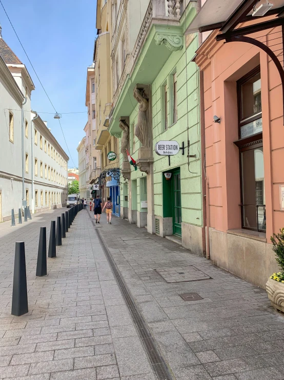 several cars sitting on the side of an empty street