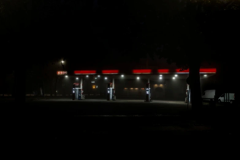 the lit up gas station at night has no lights on
