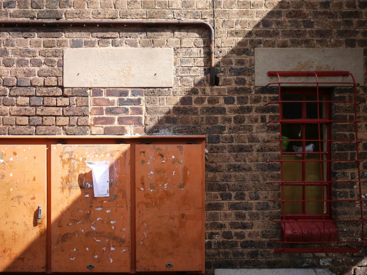 a brown door and some brick walls and red steps