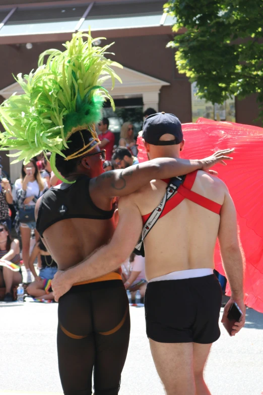 a man in  lingerie dancing with his arm around a dancer