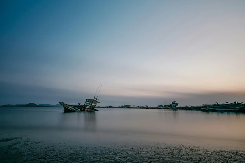 the old ship is pulled into the shore by a crane