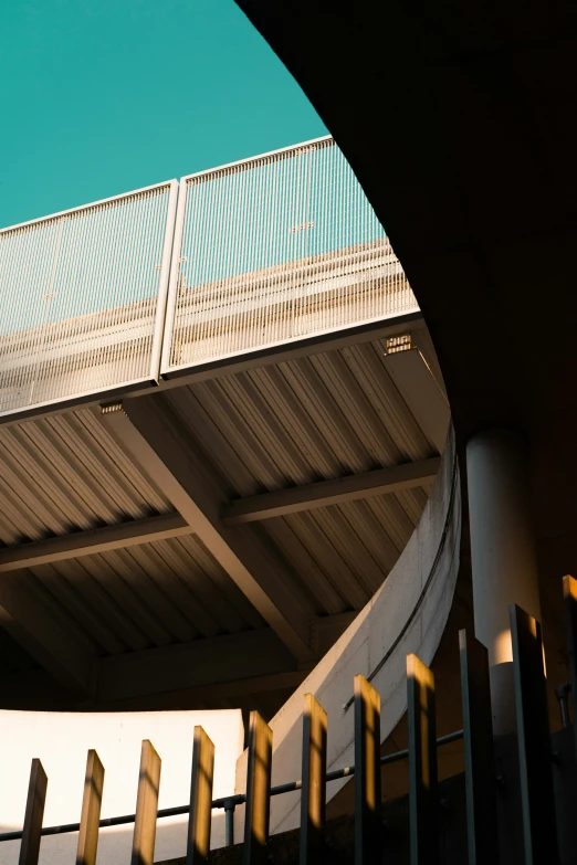 a metal railing and a white building against the sky