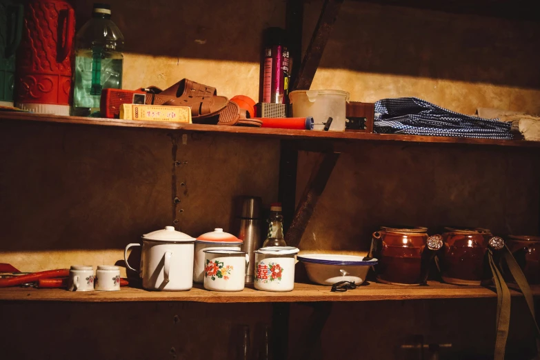 a couple of shelves holding various dishes and cups