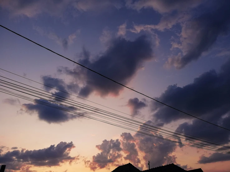 telephone wires in the sky and an airplane passing