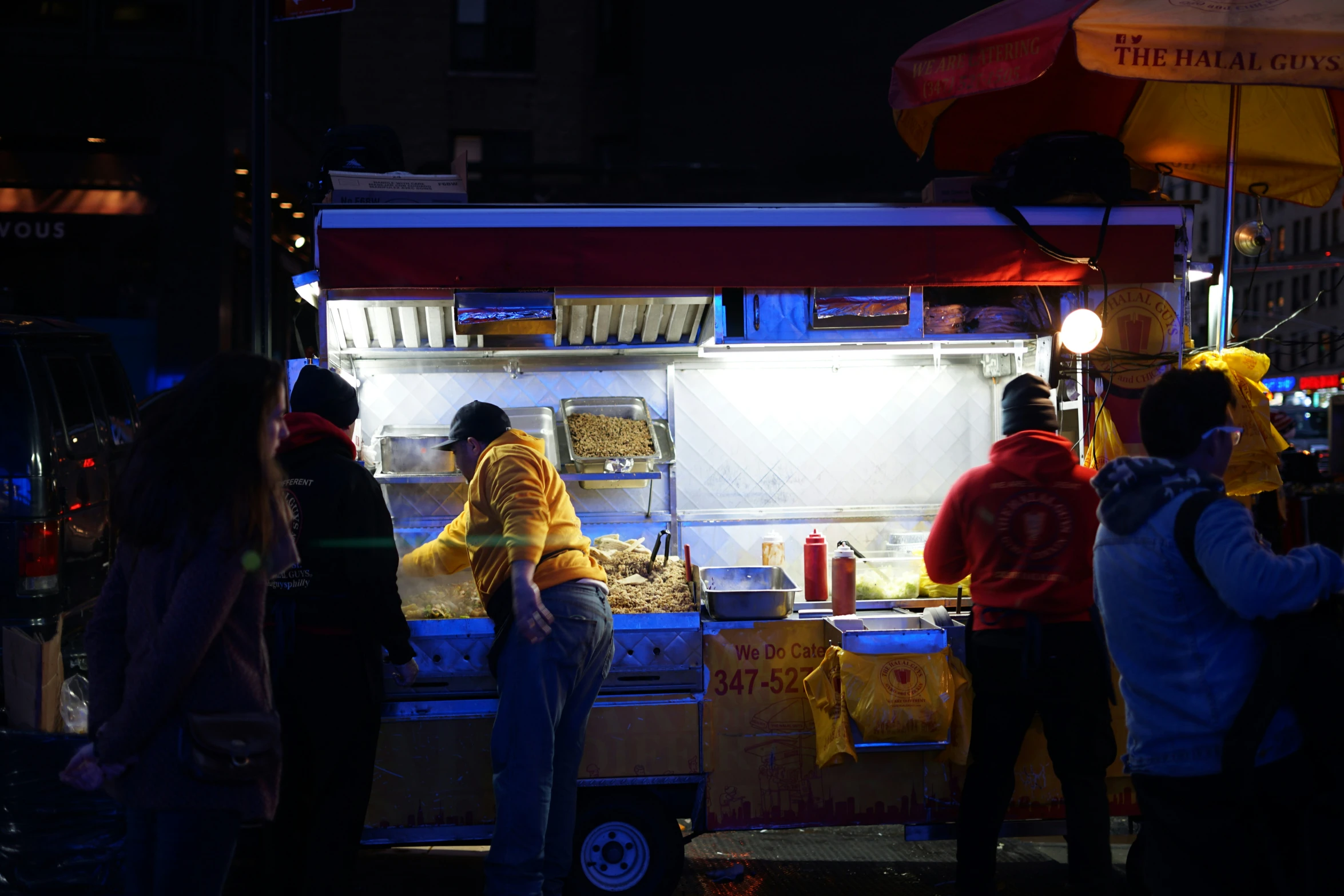 people line up outside a restaurant to buy food