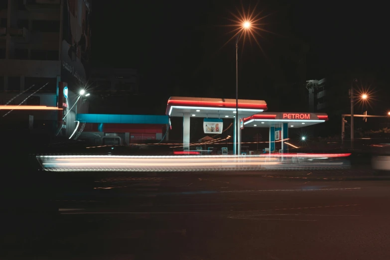 a gas station with bright lights at night