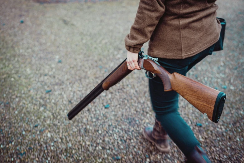 a man holding a rifle in his hand