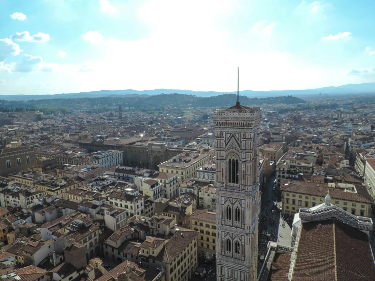 an aerial view of a clock tower on top of buildings