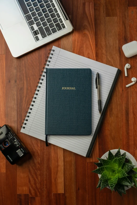 a notebook that is sitting on the floor next to a laptop