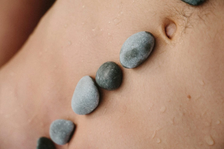 several gray rocks sitting on top of the belly