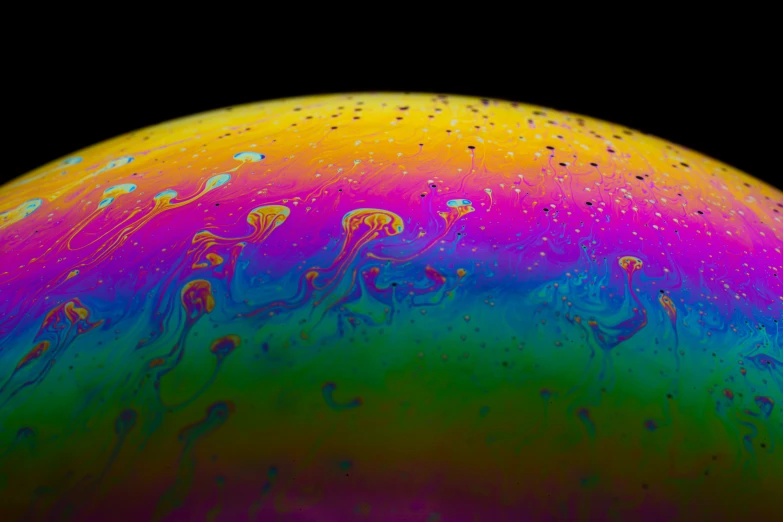 an extreme close up of the outside of a soapy liquid ball