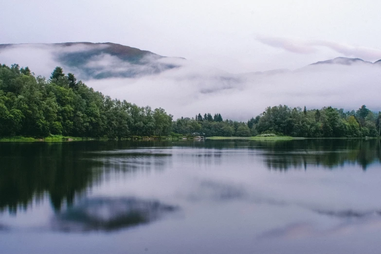 a small body of water surrounded by mountains