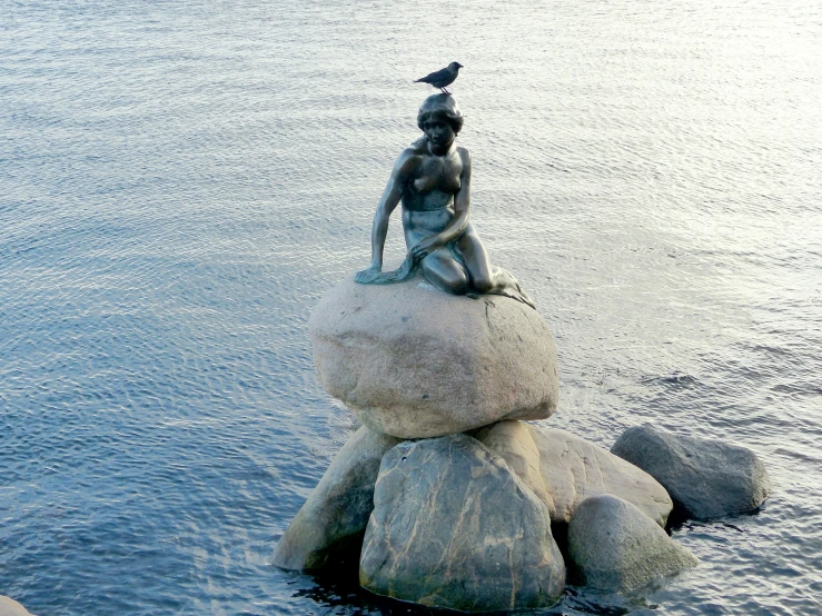 there is a statue that has been placed on rocks