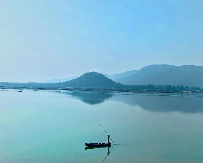 a man standing in a boat on the ocean