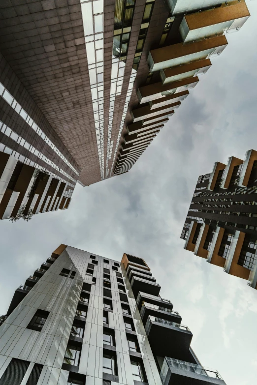 a view looking up at high rise buildings from below