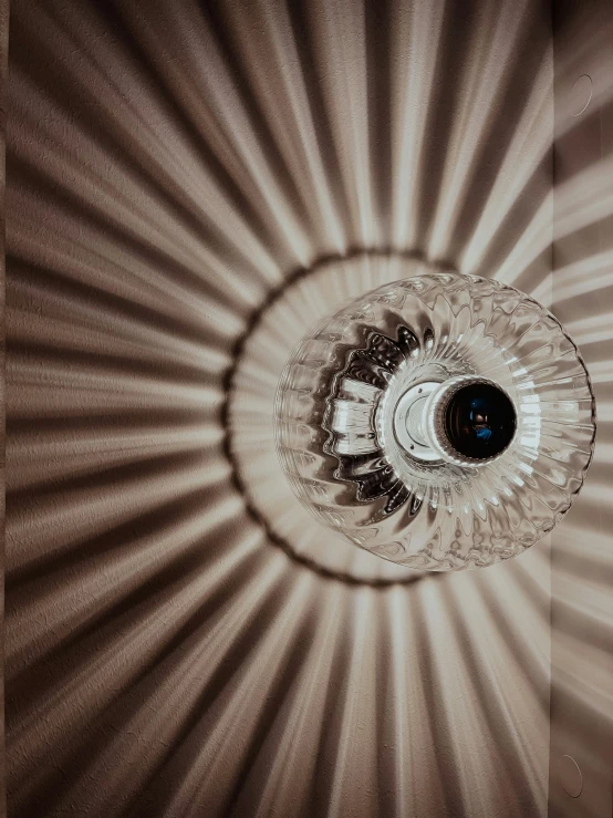 a round light fixture hanging from a ceiling